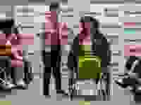 Two disabled people on runway showcasing clothes.