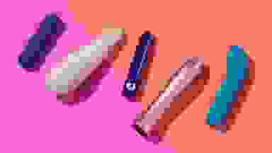 A collection of the best bullet vibrators including the PlusOne bullet vibrator​, the Maude Vibe, the Lovehoney Magic Bullet, the Femme Funn Bougie Bullet and the Je Joue G-Spot Bullet Vibrator for Intense Pleasure on a pink and orange background.
