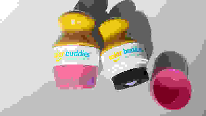 Two Solar Buddies Sunscreen applicators on a white background.
