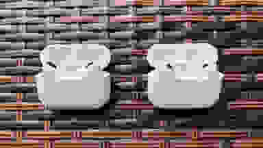 The white AirPods Pro case sits open next to the very similar AirPods Pro (2nd gen) case