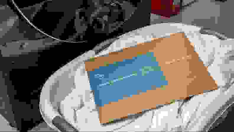 A cardboard sleeve of Hey Sunday laundry detergent sheets in a basket.