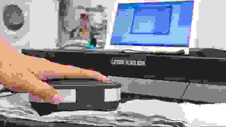 A spectrophotometer scanning a stain strip.
