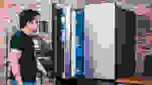 A person pulling a door open on a French-door refrigerator