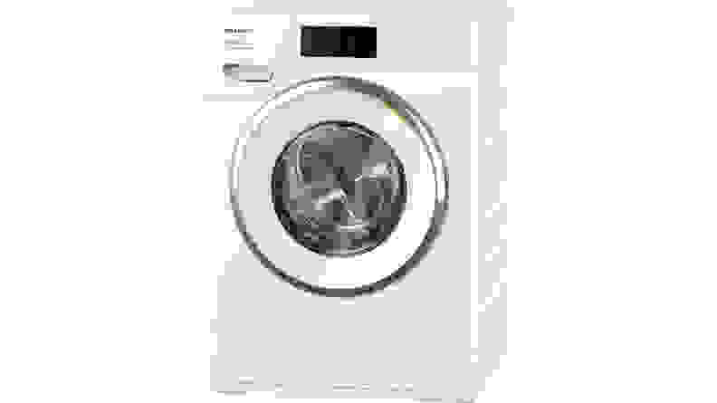 The Miele W1 compact washer sits in a white space.