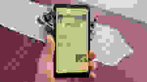 An Onyx Palma e-reader being held in a living room.