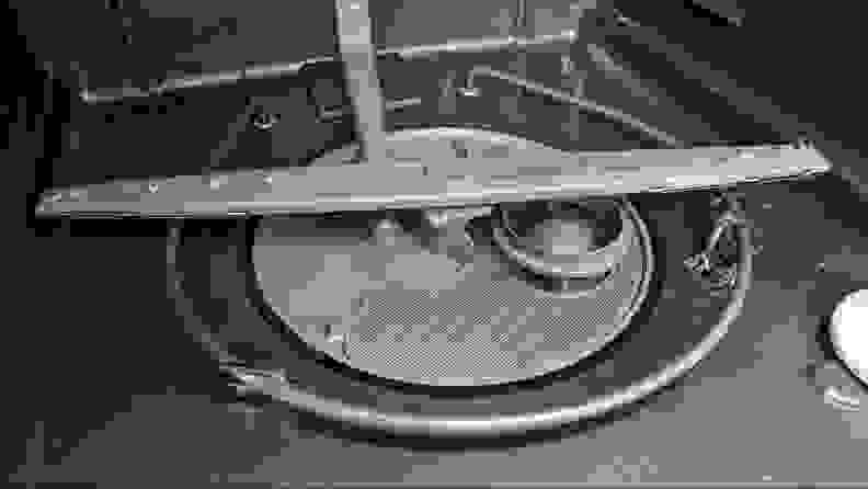 A close-up of the bottom of the wash tub, showcasing the heating element wrapped around the filter in a circular shape.