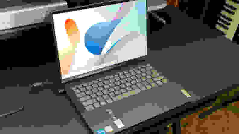 An open and powered on laptop showing a colorful image on its display