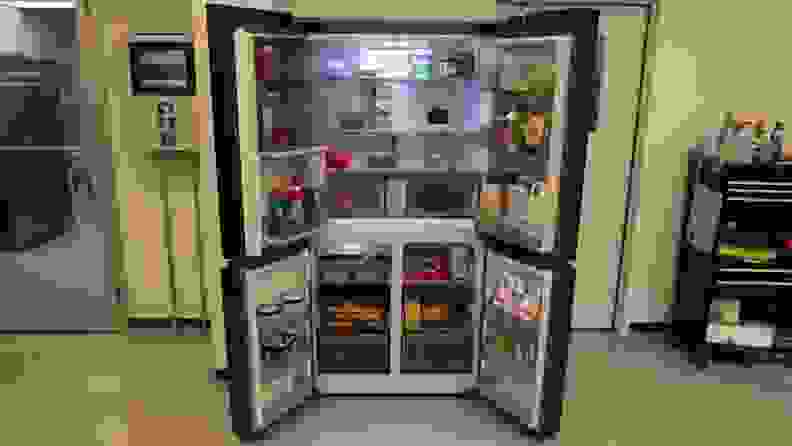 All four doors open on the Samsung Bespoke RF23DB9700QL Refrigerator to showcase assorted foods and beverages.