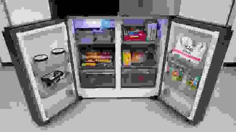 A closer view of the roomy freezer compartment located on the bottom of the Samsung Bespoke RF23DB9700QL Refrigerator, filled with assorted frozen foods.