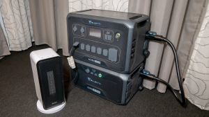 A Bluetti AC300+B300 Home Battery Backup appears in a carpeted room with a Govee electric space heater for testing.