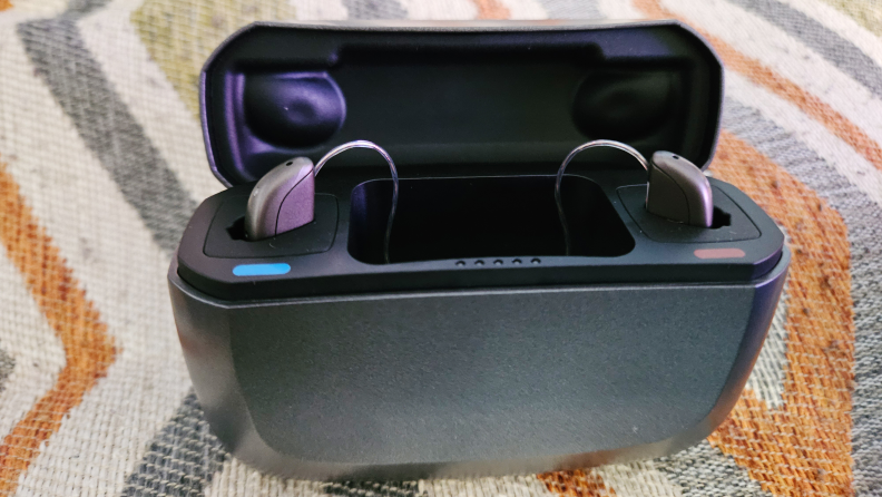 Black Jabra Enhance Select 500 hearing aid case with hearing aids inserted