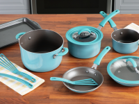 A set of nonstick cookware and utensils on a wooden surface