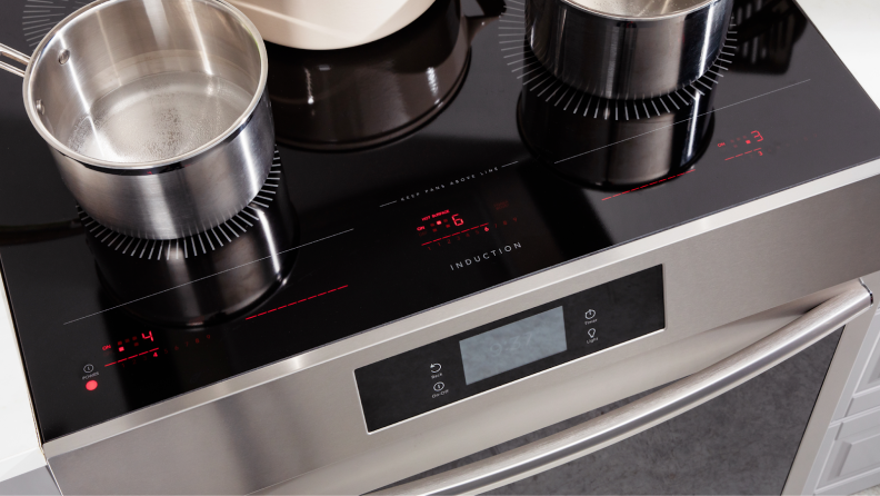 Aerial view of several stainless steel pots sitting on the cooktop of the Frigidaire Gallery GCFI3060BF 30-inch Induction Range.