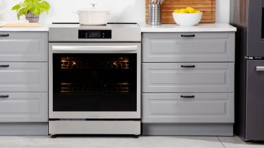 Frigidaire Gallery GCFI3060BF 30-inch Induction Range in between two drawers in modern kitchen setting.