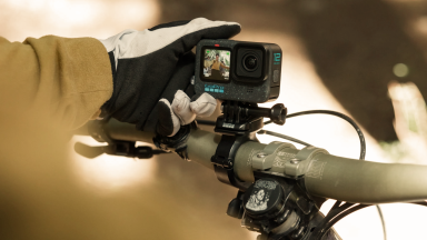 Photo of a model holding a GoPro Hero action camera.