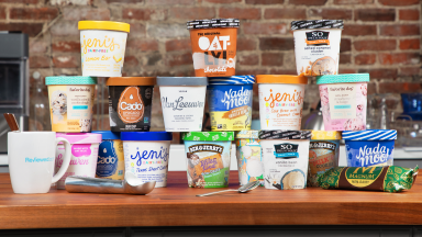 Pints of dairy free ice cream stacked on top of each other.