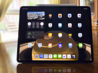 An iPad Air on a wood dining room table.