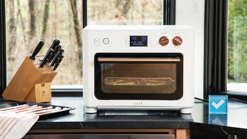 Cafe Couture countertop oven on a kitchen counter besides a knife set