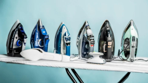 A line of steam irons on an ironing board on a blue background